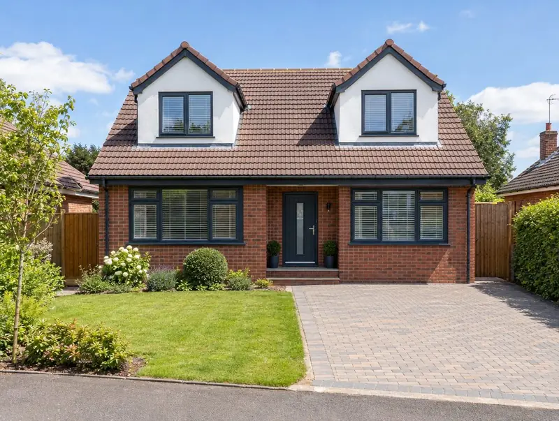 Brick bungalow converted to a chalet bungalow with two front dormer windows