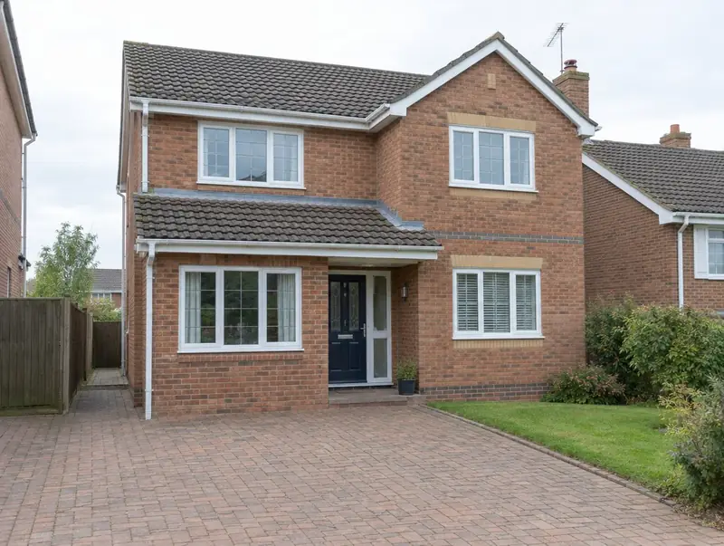 Detached house where the garage door opening has been bricked up with a new window