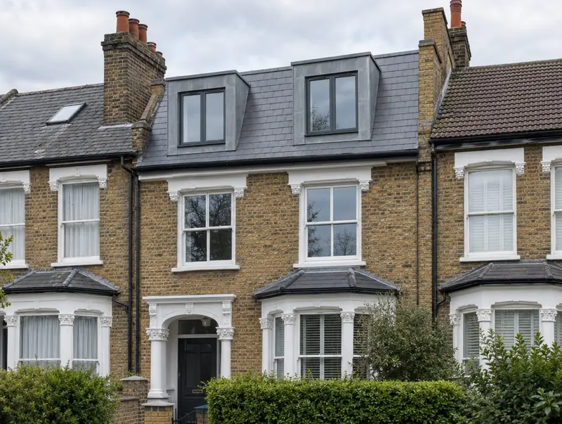 Mansard loft conversion with slate front slope and lead-clad dormers on a London terrace